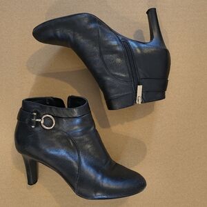 black leather Bandolino ankle boots with a side buckle and zipper closure. 